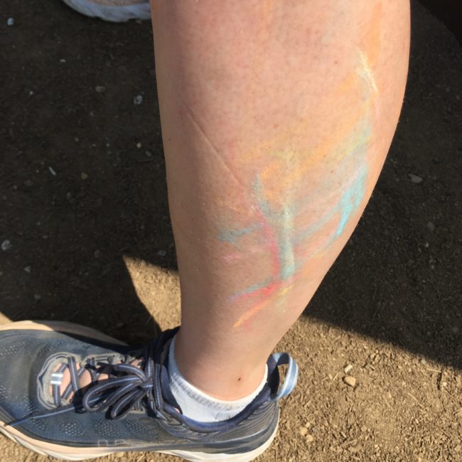 image of leg with colorful chalk marks